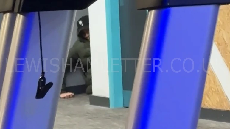 Mohammed Aminu peeking around the corner of a wall